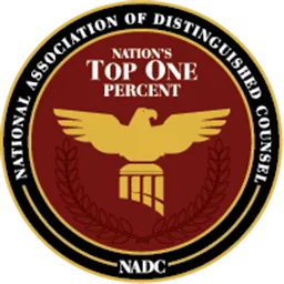 A circular emblem with a gold eagle and scales stating "Nation's Top One Percent" and "National Association of Distinguished Counsel.